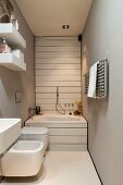 Well-appointed, narrow bathroom with grey walls