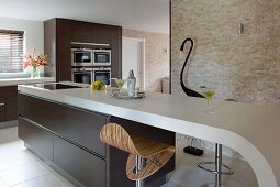 Elegant kitchen in shades of brown with curved kitchen counter