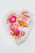 Assorted sewing and craft supplies in a heart shape