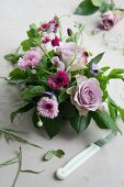 Table decoration made of roses, corn flower and vetches