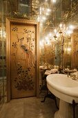 Door painted with Chinese motif in ensuite bathroom with mirrored ceiling and walls