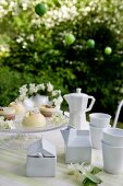 White porcelain crockery and sweet petits fours on a table outdoors