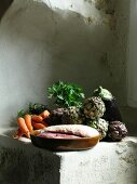 Entenbrust, Auberginen, Artischocken und Karotten auf einem verputzten Sandsteinsims