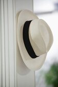 White summer hat hanging on peg