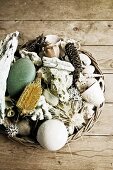 Basket of beach finds on wooden surface