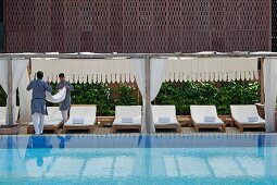 Hotelpersonal arbeitet am luxuriösen Swimmingpool im Hotel Raas Haveli, Jodhpur, Indien