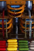 Colourful rolls of yarn in loom