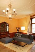 Elegant seating area with simple designer furniture in historic setting in modern, stately home hotel (Schloss Schauenstein)