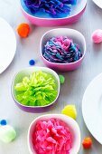 Colourful bowls & pompoms decorating table