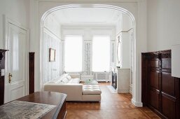 White leather sofa combination in grand period apartment with artistic wall panelling and elegant parquet floor