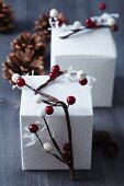 Gift boxes decorated with garlands of red and white berries