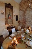 Old, exposed brick masonry in old building as backdrop for long, festively set, Rococo-style table