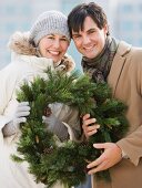 Couple holding wreath