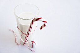 Parcel ornament next to glass of milk with candy cane