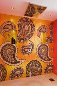Bathroom wall with gold mosaic tiles and paisley pattern