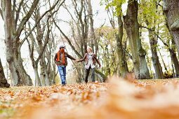 Couple strolling through autumnal woodland