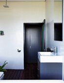 Washstand in purist bathroom with exotic wood board floor