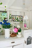 Bouquets on white chest of drawers in white wooden veranda