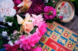 Blüten von geschnittenen Rosen und Pfingstrosen in Weiß, Pink und Violett