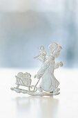 A pewter Christmas figurine: a Christmas angel with a sleigh