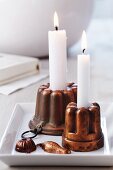 Copper jelly moulds used as candlesticks