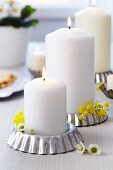 Tart tins used as candle holders decorated with waxflowers & mimosa flowers