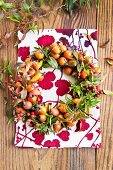 Wreath of various rosehips and branches of spirea leaves in autumnal colouring