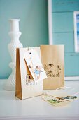 Paper bags decorated with small drawings used as gift packaging