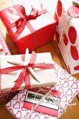 Christmas presents wrapped in red and white paper and ribbons