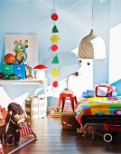 Child's bedroom with pale blue walls and hand-made Christmas garland