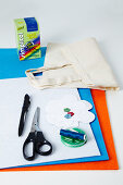 Craft materials for decorating cloth bag - scissors, sheets of colourful felt and cloth bag