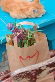 Flower arrangement of snake's head fritillaries in paper bag