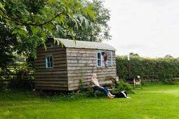 Idyllic shepherd's hut, two women and dog in the country