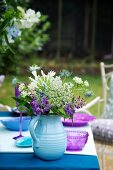Summery bouquet on set table in garden