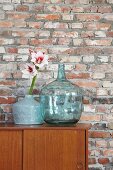 Amaryllis flowers against rustic brick wall