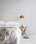 Bed with perforated panel as headboard