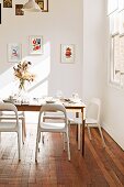 Light falls into the simple dining room with wooden floor