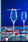 Oriental place setting: thin sheet of pastry and crab apple on stemmed glass