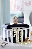 Black and white jewellery box with handle hand-made from stacked wooden beads
