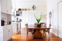 Large dining table and wooden chairs in open-plan kitchen