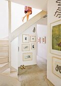 Open-plan stairwell with framed pictures on wall