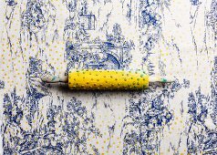 Printing yellow polka-dots on toile de jouy tablecloth using a modified rolling pin