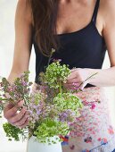 Young woman arranging summer flowers