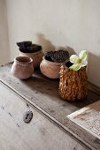 Wood and ceramic pots on rustic writing desk