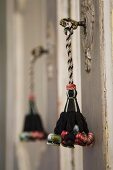 Cord tassel in dark brown and pastel colours hanging from vintage key