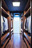 Elegant dressing room with wooden, open-fronted wardrobes