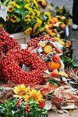 Wreath of rosehips and natural craft utensils on an autumn market stall