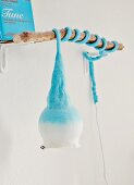 Pale blue, Danish lamp with felt cover wrapped around piece of branch