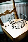 Wire basket with handle on old kitchen chair