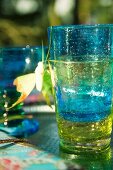 Stacked, colourful drinking glasses